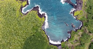 Aerial video of Honokalani Black Sand Beach in Waianapanapa State Park on the Road To Hana in Maui, Hawaii