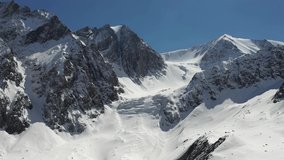Aerial video from drone of Altai natural mountain landscape. Trough valley with Aktru (Akturu) glacier. Popular place for alpinism and hiking. Camera moves backwards. Altai, Siberia, Russia.