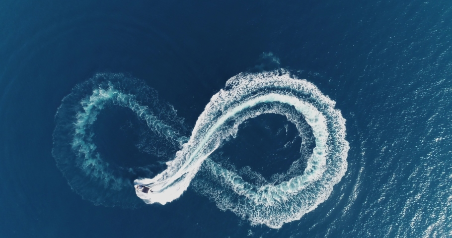Aerial top view of a white pleasure boat on a summer day. Powerboat turn loop eight on the sea making infinity future concept.  | Shutterstock HD Video #1092517639