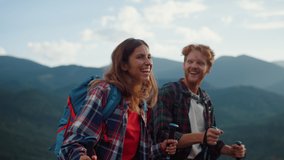 Laughing couple trekking mountains hike. Close up two tourists smile together outside on family vacation. Joyful backpackers enjoy walk in summer nature. Wanderlust happiness relationship concept. - Powered by Shutterstock - Get 15% off with code: PIKWIZARD15