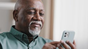 Close up bald American bearded old senior man with gray beard. elderly male using software application net on cellphone reading message email swiping browsing online app. smartphone Wi-Fi technology - Powered by Shutterstock - Get 15% off with code: PIKWIZARD15