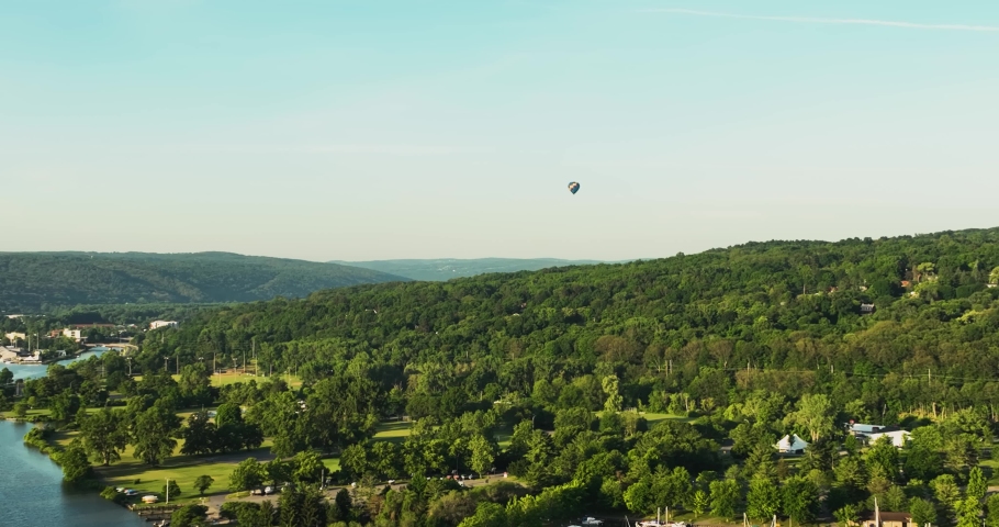 Ithaca NY USA June 26, 2022: Beautiful Hot Air Balloon near Ithaca, NY, traveling over the Cayuga Inlet and Cayuga Lake on a sunny Sunday morning