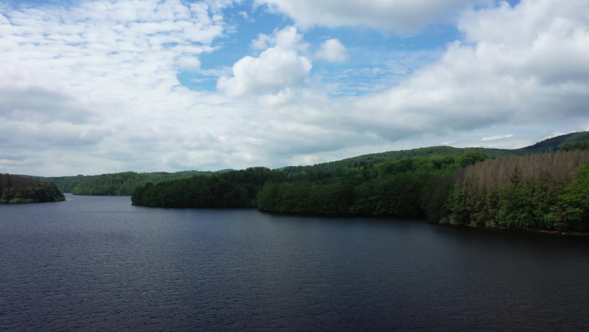 Lake Chaumecon and its green forests in Europe, France, Burgundy, Nievre, Morvan, in summer, on a sunny day.