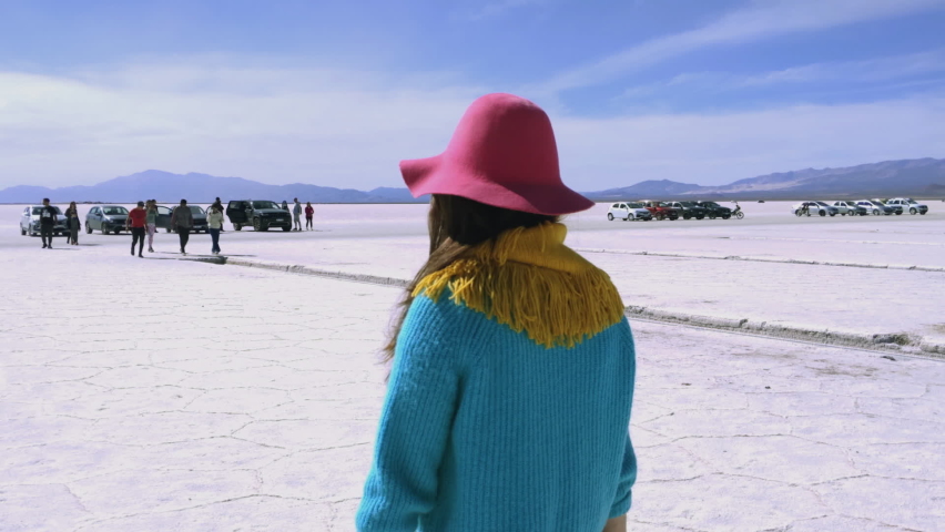 Woman Walking in Salinas Grandes Salt Flats, Jujuy Province, North West of Argentina, South America. Slow Motion.