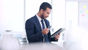 Male executive online shopping, buying with a corporate credit card. A smiling man paying business bills, sitting on an office desk. Happy guy making a purchase on a digital tab. - Powered by Shutterstock - Get 15% off with code: PIKWIZARD15