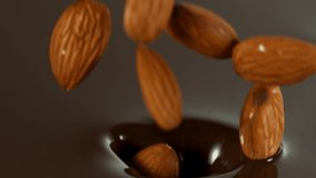 Super Slow Motion of Falling Almonds into Dark Hot Melted Chocolate, Close-up. Filmed on High-Speed Cinema Camera, 1000 Fps. - Powered by Shutterstock - Get 15% off with code: PIKWIZARD15