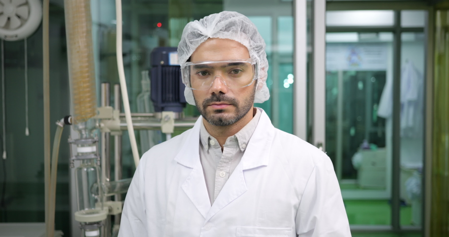 Slow motion shot of professional male scientist crossing arms looking at camera in the laboratory, Smart scientist portrait concept | Shutterstock HD Video #1092552645