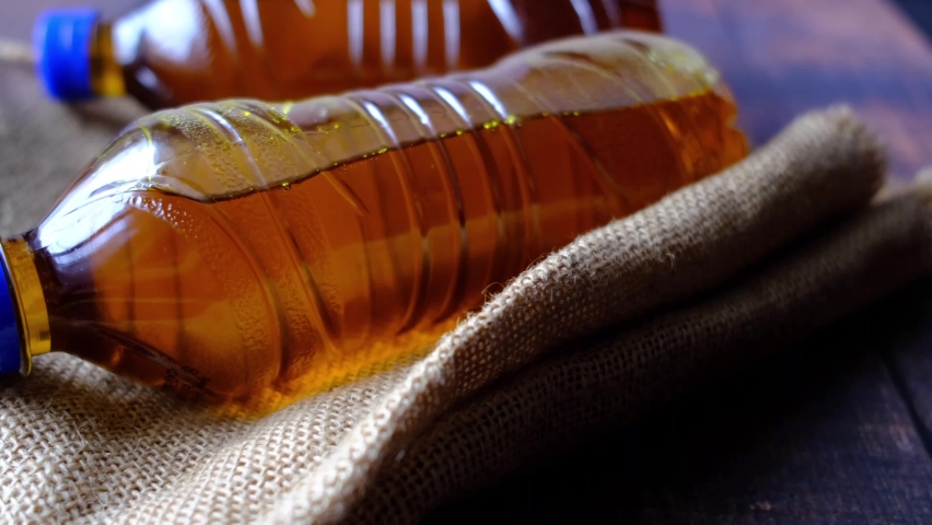 Mustard oil in a plastic jar on table 