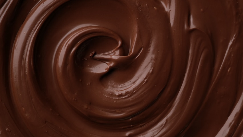Zoom footage liquid dark chocolate top view. Confectionery concept