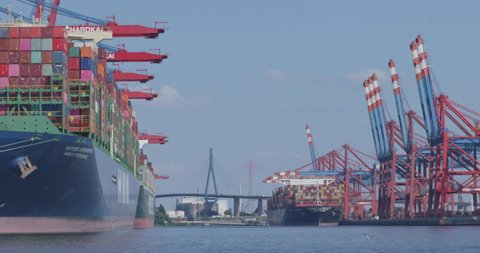 HAMBURG, GERMANY june 2022: Gantry crane and huge container ship at daytime in the port of Hamburg