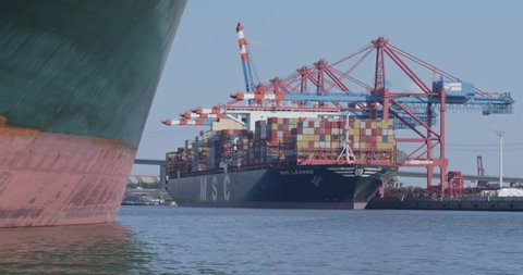 HAMBURG, GERMANY june 2022: Gantry crane and huge container ship at daytime in the port of Hamburg