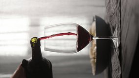 Vertical pour red wine into wineglass with fusilli pasta on background - Powered by Shutterstock - Get 15% off with code: PIKWIZARD15