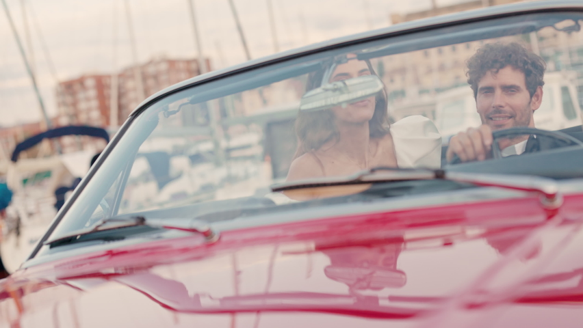 Young Couple In Red Car. Pretty Brunette In White Dress.