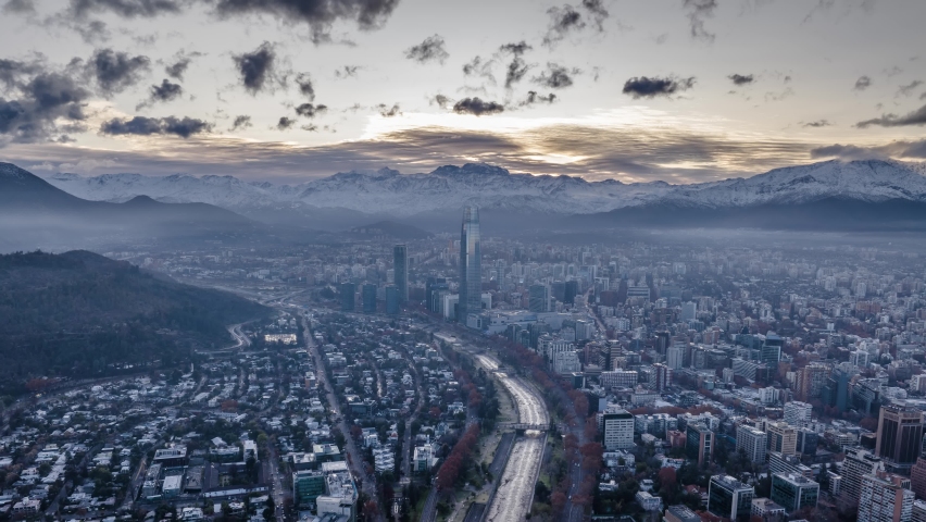 Aerial hyperlapse of Santiago of Chile with the snowy Andes mountains in the background