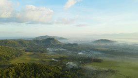 Aerial Video of Indonesia Agriculture Land during sunrise, hill and fog background
