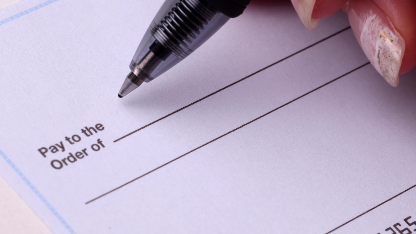 Close-up shot of a check being writen.