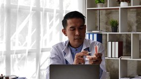 Online medical consultation. Asian people Male dentist communicating with his patient via internet connection.