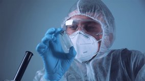 Scientist holding ampule with white powder, illegal pharmacy production, drugs. Laboratory assistant examines glass medical ampoule for injection. Penicillin dry powder medicine. Antibiotic injection. - Powered by Shutterstock - Get 15% off with code: PIKWIZARD15