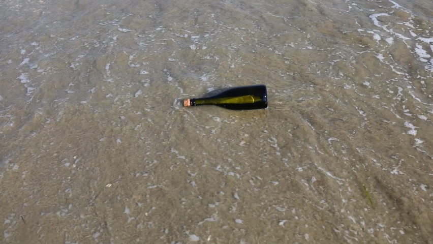 bottle with a secret message carried by the waves of the sea