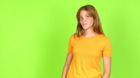 Young pretty blonde woman on green screen chroma key presenting something over isolated background