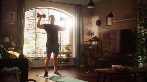 Strong Athletic Asian Man Does Workout at Home, Training with Dumbbells. Fit Muscular Sportsman Staying Healthy, Training at Home. Sweat, Determination of a Handsome  Man. Static Wide Shot