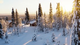 Aerial view across glowing morning sunrise shining through snow covered woodland trees and idyllic rural cabin - Powered by Shutterstock - Get 15% off with code: PIKWIZARD15