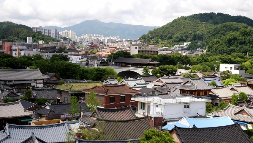 Aerial panoramic shot of traditional Hanok Village in scenic landscape and Downtown of Jeonju city in background - South Korea,Asia