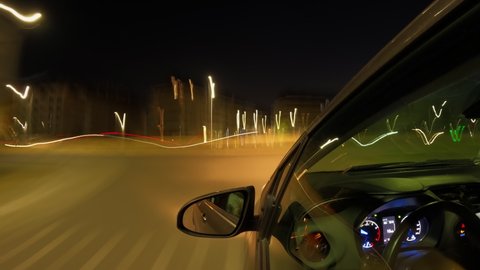 City at night from the perspective of a car driver, timelapse of night driving on illuminated streets. View from the car.