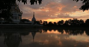 4K video background of the morning sun light Seeing the old chedi in the middle of the water (Wat Thung Setthi) in Khon Kaen of Thailand, is beautiful and has a blur of the wind blowing.