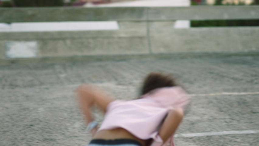 Trendy freestyle dancer practicing choreography in a city. Modern, funky and edgy young woman dancing with powerful contemporary moves. Performing with cool attitude, expressive motion and rhythm