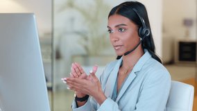 Call center agent talking and advising clients while working on a desktop computer in an office alone at work. Young Indian customer service agent wearing a headset and giving help to people - Powered by Shutterstock - Get 15% off with code: PIKWIZARD15