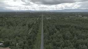 Aerial shot with drone Image of green forrest near railroad in Thailand.