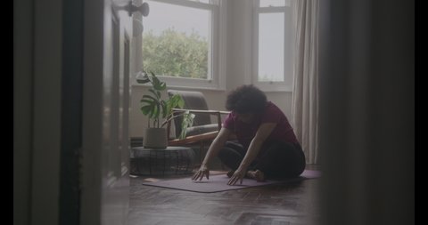 Active Mature Adult Woman Exercising Yoga at Home Stockvideó