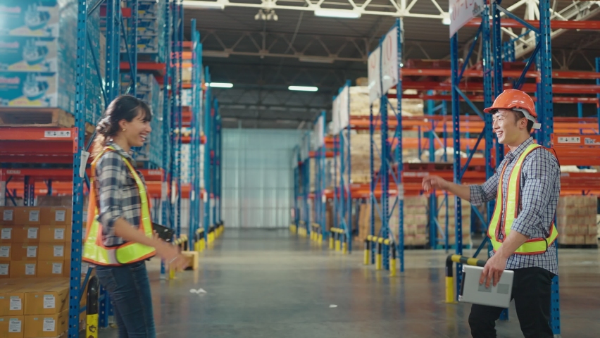 Colleague workers in warehouse factory have a greeting by high five with hands raised up at factory warehouse, Worker team working in the warehouse | Shutterstock HD Video #1092625447