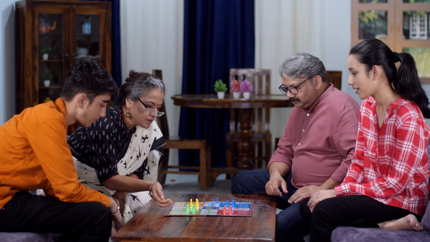 An old Indian couple and their children playing a board game - a childhood game, happy nuclear family, retired parents. Young kids spending quality time with their parents - two generations, leisur... Royalty-Free Stock Footage #1092627123