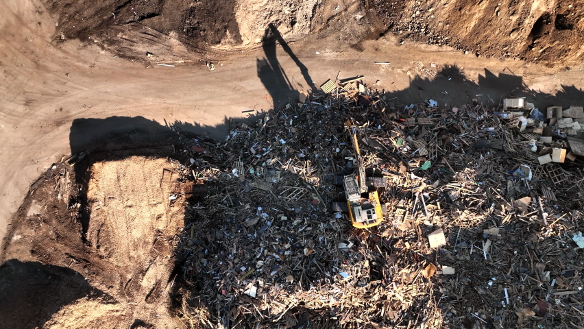 Landfill with Construction waste (CDW). Trash disposal for recycling and re-use. Excavator log grab crane on landfill. Recycling of Construction waste or debris. Secondary raw. Wood Waste Recycling.
 Royalty-Free Stock Footage #1092627249