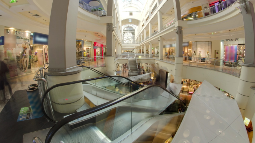 Many shops in multi-level department store or shoping mall timelapse hyperlapse. Escalator between floors
