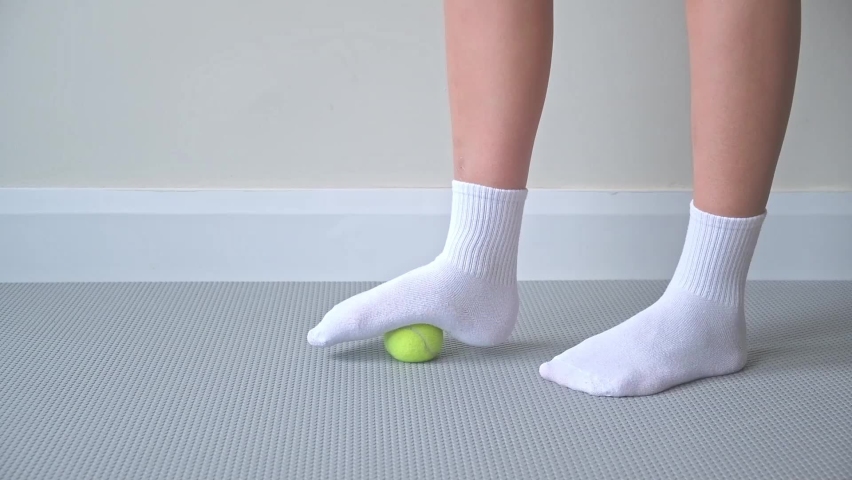 Myofascial release, Foot fascia massage with a ball, fitness, self-care, health, smart fitness. Myofascial relaxation of foot muscles with a massage ball on a mat at home, close-up | Shutterstock HD Video #1092629677