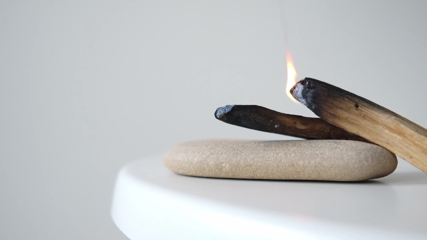 Palo Santo sticks on a light background.Aromatherapy religious rituals meditation.Wellness with aromatherapy and the occult.Healing incense Palo Santo.Organic incense of the holy ritual tree.Ibiokai | Shutterstock HD Video #1092629681