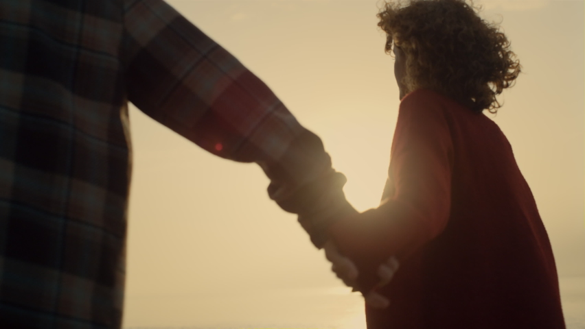Romantic couple dating on beach at sunrise. Loving woman and man holding hands. Happy lovers having fun on beach at sunset. Fashionable girl and guy spending summer vacation at sea. Happiness concept  | Shutterstock HD Video #1092631939