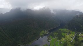 Mountains, waterfall, fog, rain. Drone flying through the clouds. Natural landscape in rainy weather. Mountains of Norway, Vaksdal Municipality. Video 4k