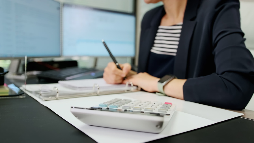 Close up view of woman accountant working using calculator. Make payments on-line through bank system, analyze company charges calculate expenses concept Royalty-Free Stock Footage #1092642427