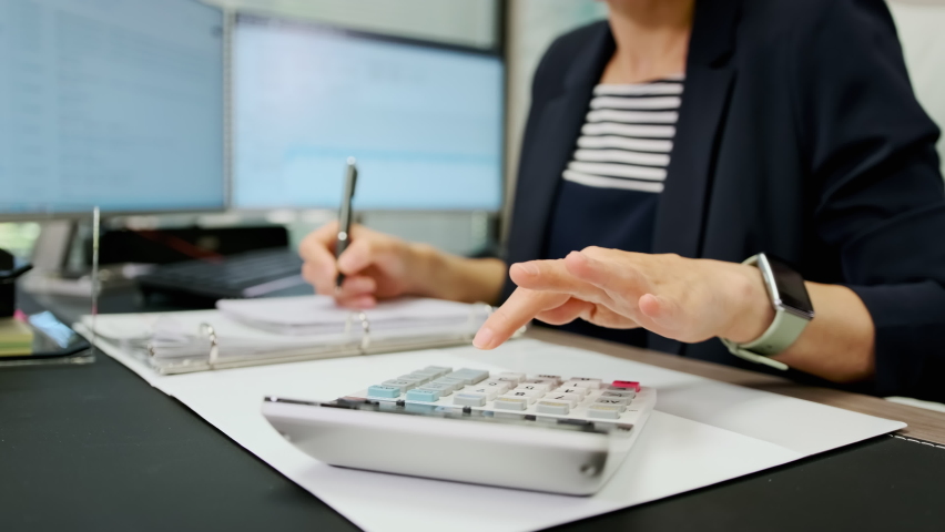 Close up view of woman accountant working using calculator. Make payments on-line through bank system, analyze company charges calculate expenses concept Royalty-Free Stock Footage #1092642427