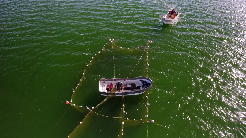 Aerial view to the Baltic sea with the fish traps and fishers. Drone video