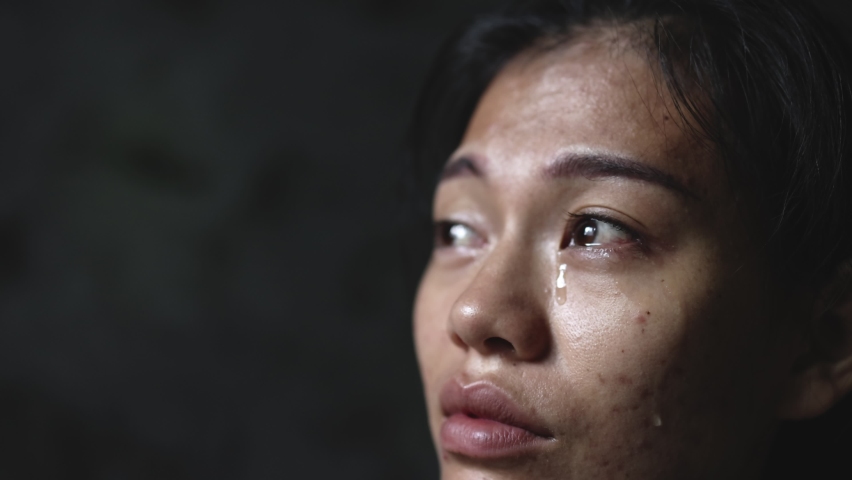 Slow motion, Close-up of a woman crying, tears streaming down her face. Concept to stop violence against women, human trafficking, rape. Royalty-Free Stock Footage #1092663115