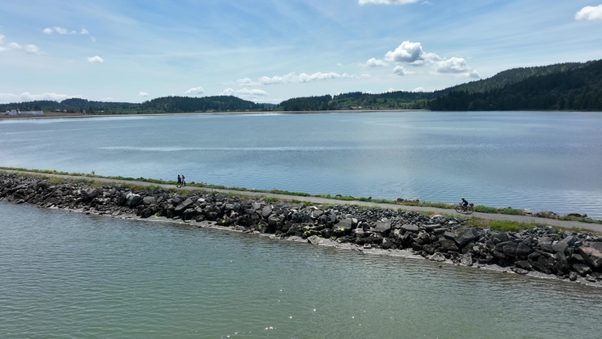 Side scrolling shot of a cyclist on the Weavering Spit in Fidalgo Bay.