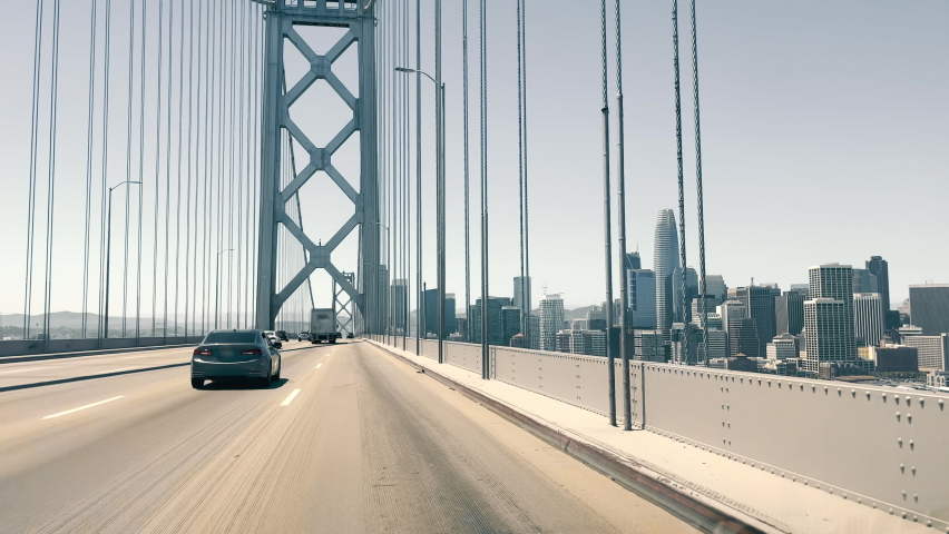 View through the windshield of a car driving over the Oakland Bay Bridge in San Francisco. View of Downtown San Francisco from the bridge. Royalty-Free Stock Footage #1092675163