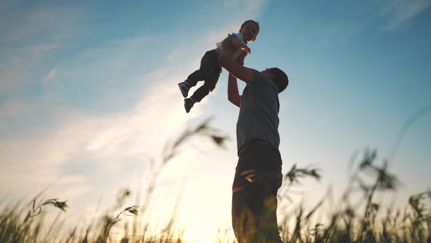 father playing with son in the park. happy family kid dream concept. father throws baby up silhouette in summer at sunset. parent and child play toss up silhouette lifestyle outdoors in the park Royalty-Free Stock Footage #1092676621