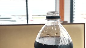 cola carbonated drink. American drink in a plastic bottle in a fast food cafe at a gas station. cola lemonade drink. lifestyle drink with ice in cafe - Powered by Shutterstock - Get 15% off with code: PIKWIZARD15