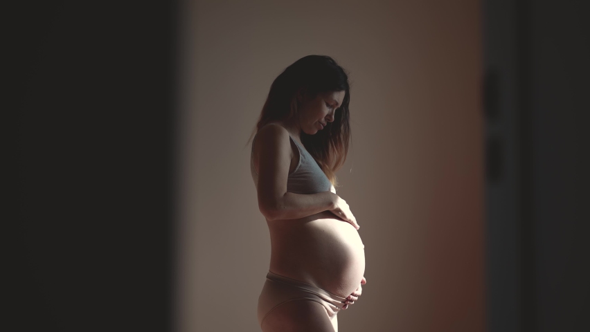 pregnant woman. health pregnancy motherhood indoors procreation concept. close-up belly of a pregnant woman. woman waiting for a newborn baby. pregnant woman holding her belly sunlight Royalty-Free Stock Footage #1092676741